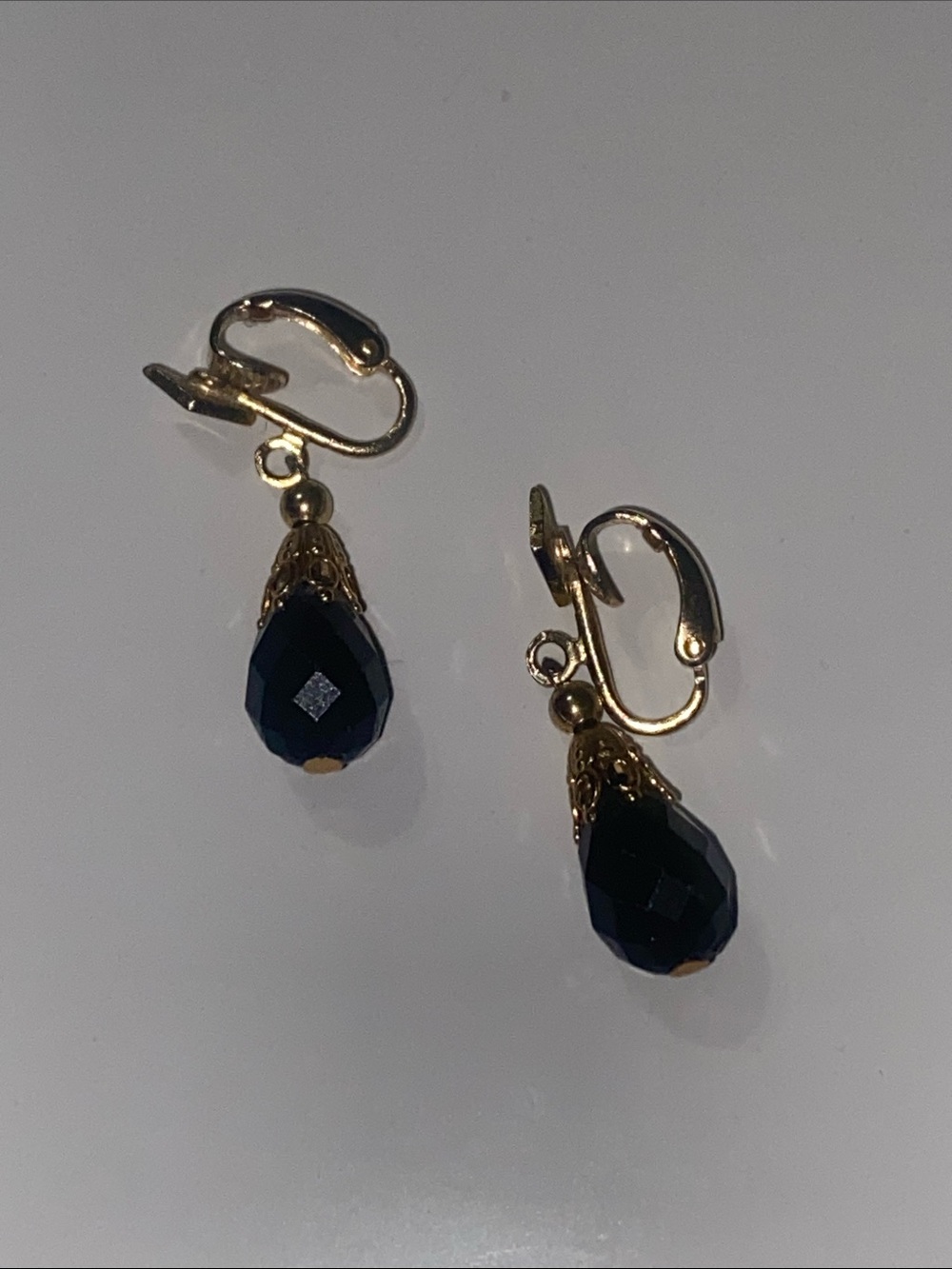 Gold Clip-On Earrings with Black Teardrop Beads